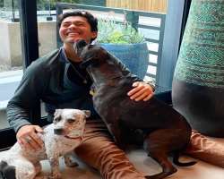 He is a person who loves dog and show his kind behavior towards them.